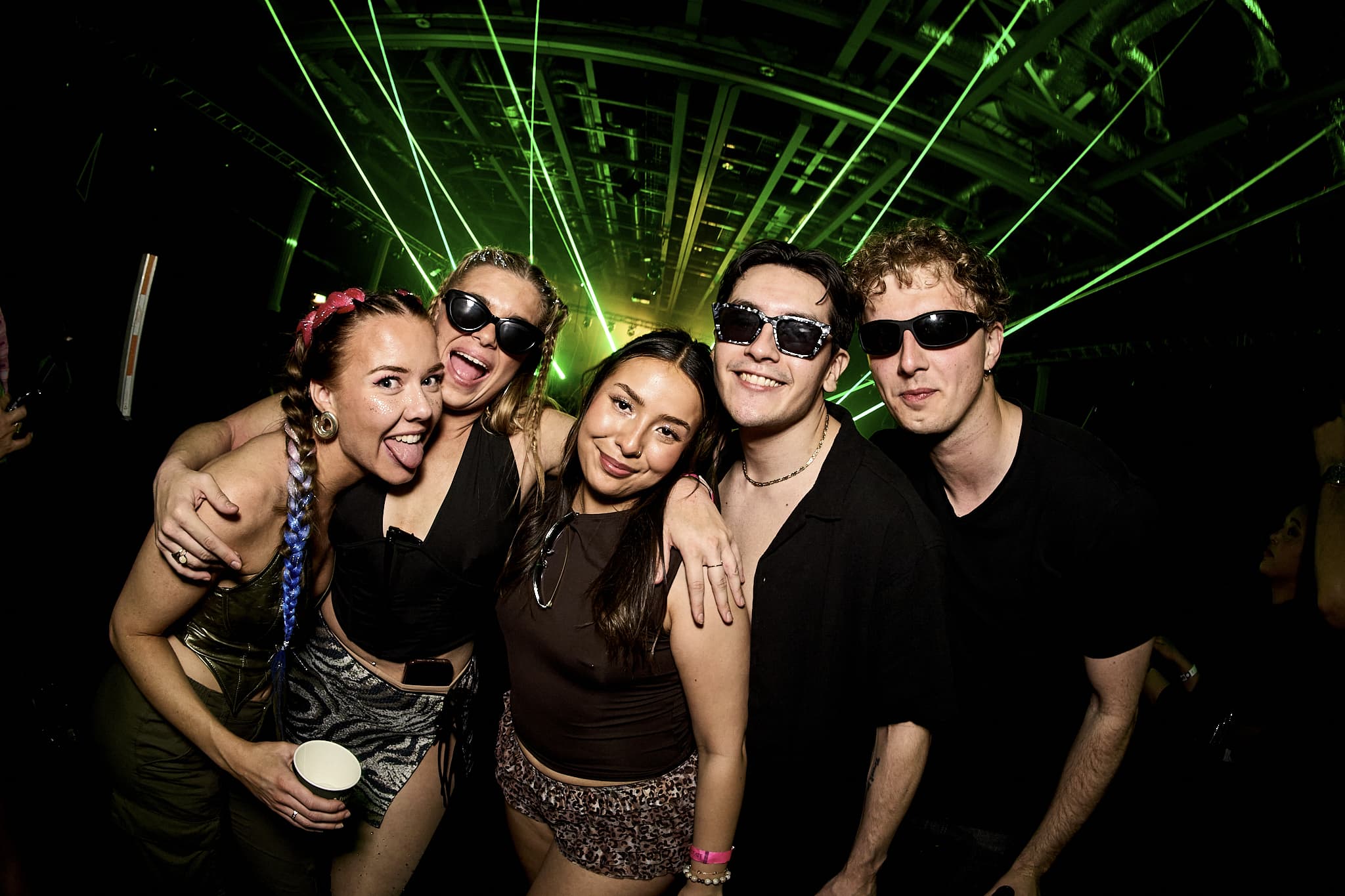 DJ performing beneath bright white stage lights